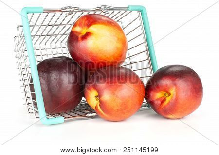 Lot Of Whole Ripe Deep Red Nectarine Out Of A Shopping Basket Isolated On White