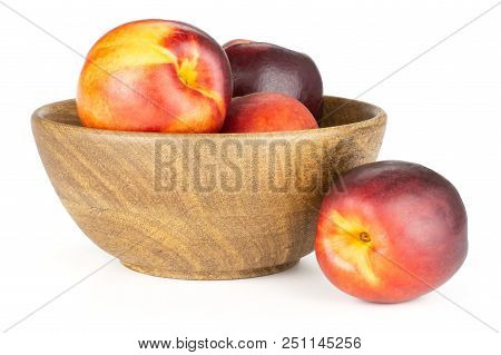 Lot Of Whole Ripe Deep Red Nectarine In A Wooden Bowl Isolated On White