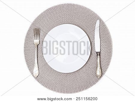 Empty Plate On A Gray Napkin. Empty Plate And Cutlery. Silverware And A White Plate. A White Saucer 