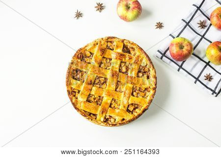 Traditional American Apple Pie With Dough Decoration In A Grid On A White Table. Autumn Baking Conce