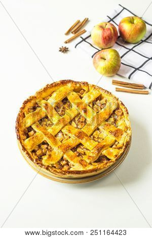 Traditional American Apple Pie With Dough Decoration In A Grid On A White Table. Autumn Baking Conce