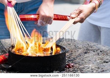 Lighting The Candle Pray To Buddha At Longhua Temple In Shanghai, China