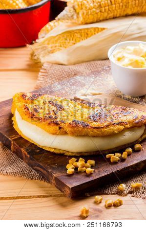 Wooden Table With Several Ingredients For The Preparation Of Cachapas With Cheese, Corn, Butter, Gro
