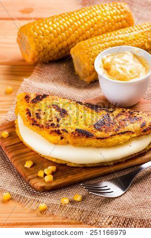 Wooden Table With Several Ingredients For The Preparation Of Cachapas With Cheese, Corn, Butter, Gro