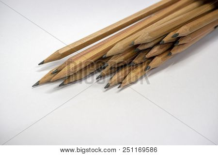 Many Brown Pencils Are Placed On Paper.