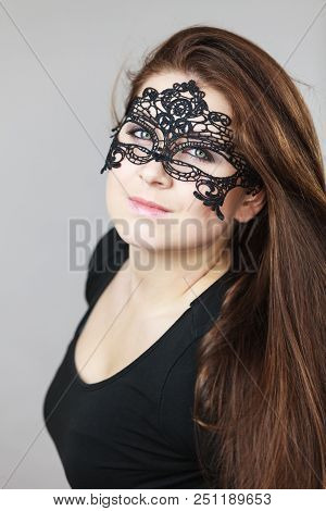 Pretty Mysterious Woman Wearing Black Eye Lace Mask Having Long Brown Hair.