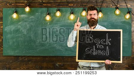 Back To School Concept. Teacher In Eyeglasses Holds Blackboard With Inscription Back To School. Man 