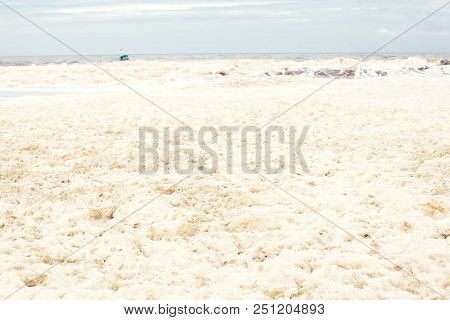 Sea And Skies And A Beach Covered In Sea Foam