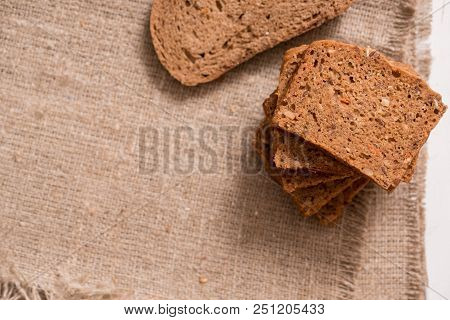 Assortment Of Baked Bread On Wooden Table Background. Top View With Copy Space
