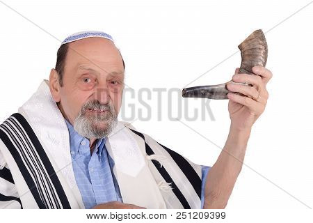 Eldery Jewish Man Blowing The Shofar Horn For The Jewish New Year Holiday (rosh Hashanah). Religion 