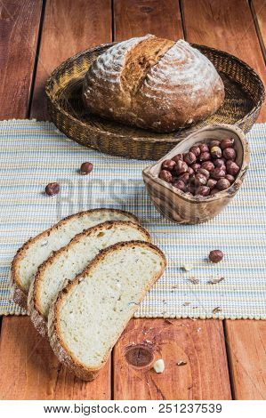 Kamut And Hazelnuts Bread On A Wooden Table Board