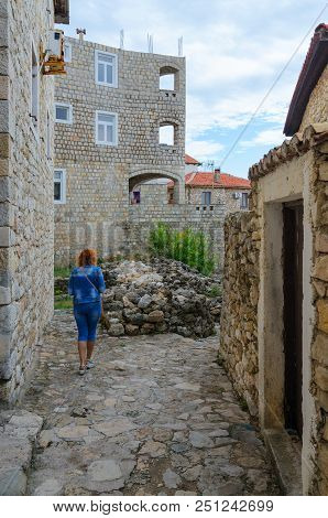 Ulcinj, Montenegro - September 9, 2017: Unknown Woman-tourist Walks Along Narrow Street In Old Town,