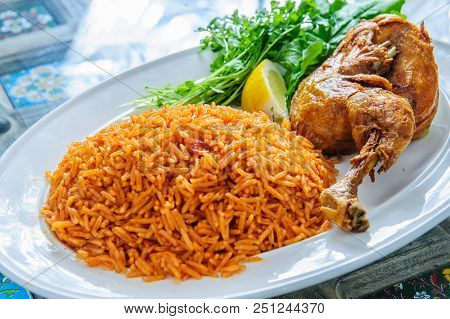 Plate Of Rice With Duck Leg And Greens.