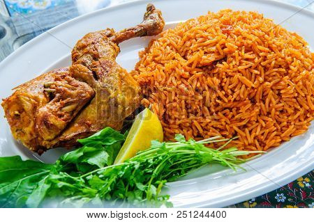 Plate Of Rice With Duck Leg And Greens.
