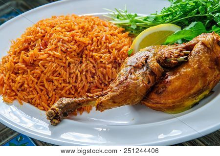 Plate Of Rice With Duck Leg And Greens.