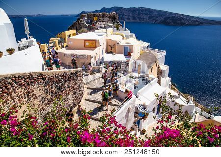 Santorini, Greece-June12, 2016: Tourists in Oia village at suny day on Santorini island on June 12, 2016, Greece.