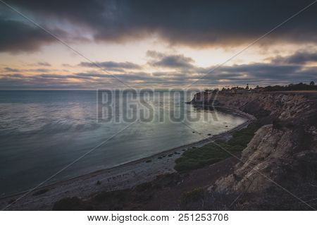 Long-exposure Coastal View Of Tall Cliffs Of Lunada Bay With Waves Crashing Onto The Shore After Sun