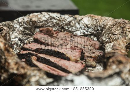 Roast Beef In Foil In A Barbecue Closeup