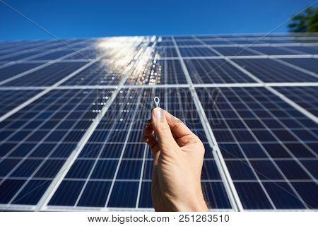 Frontview Of Worker's Hand Holding Tiny Detail For Solar Battery Installing.