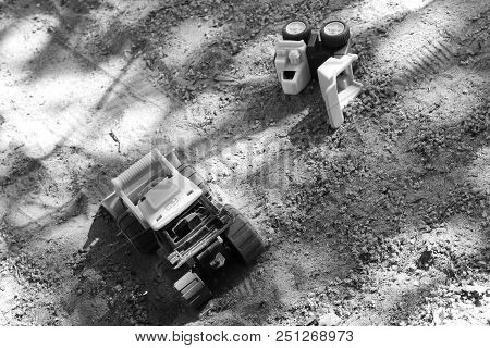 Plasti Toy Trucks Left Outside In The Sand.