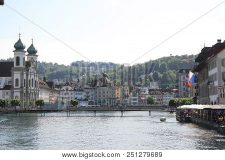 Urban Scene Of Lucerne.  People Realxing In Cafes By The Water On The Street In Old Town Of Lucerne,