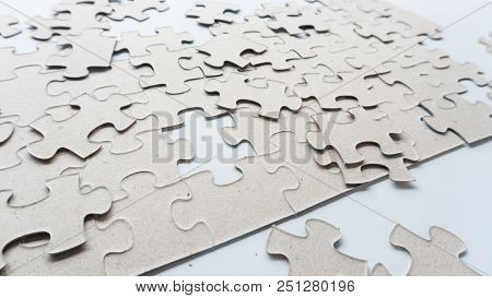 Hand Put Missing Jigsaw Puzzle Into The Paper Board