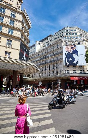 Paris, France - June 29, 2015: Boulevard Haussmann. A Woman At A Pedestrian Crossing In Front Of The