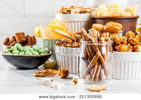 Variation Different Unhealthy Snacks Crackers, Sweet Salted Popcorn, Tortillas, Nuts, Straws, Bretse