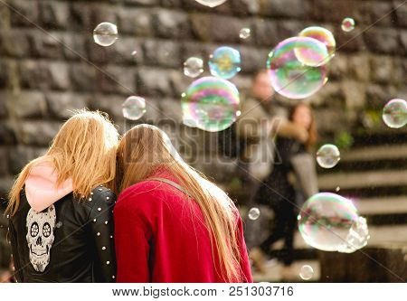 Two Young Woman Close With Bubbles Around