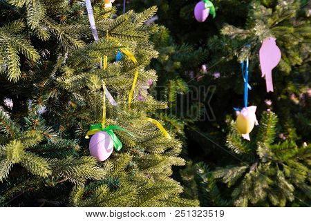 Colourful Easter Eggs Hanging On Tree Decorate  During The Season Of Eastertide.