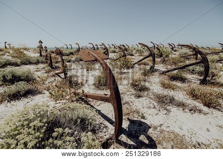 Natural Cemetery Of Marine Anchors At Barril Beach On The Southern Portuguese Coast Of The Atlantic.