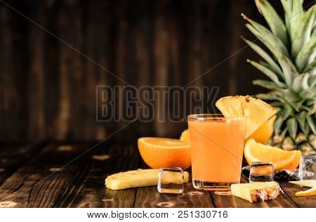 Orange And Pineapple Juice Mix On Wood Background