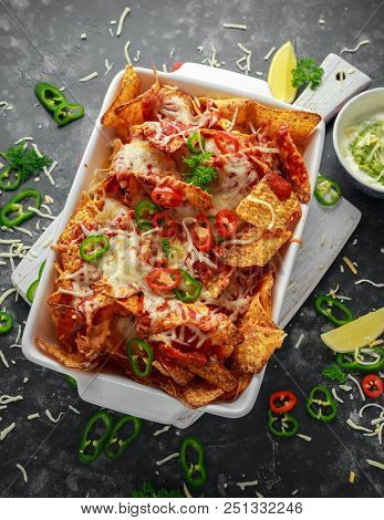 Maxican-style Tortilla Nachos Chips Topped With Tomato Salsa, Sliced Chilies And Melted Cheese Serve