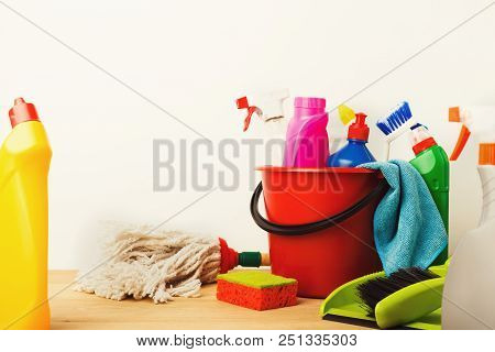 Variety Of House Cleaning Products On Wood Table At White Background, Closeup. Bucket, Brush, Rubber