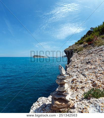 Stone Pyramid On Summer Rocky Sea Coast Baia Di Campi Vieste And Isola Di Campi On The Gargano Penin