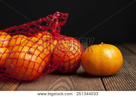 Citrus Tangerine In Oranges In Plastic Net Bag Package. No Plastic Concept. Packaging That Does Not 