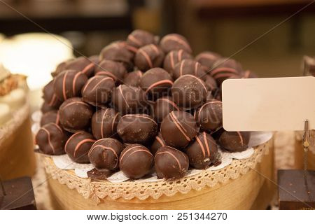 Asorted Chocolate Truffles And Pralines. Chocolate And Coconut Candies On The Counter In The Confect