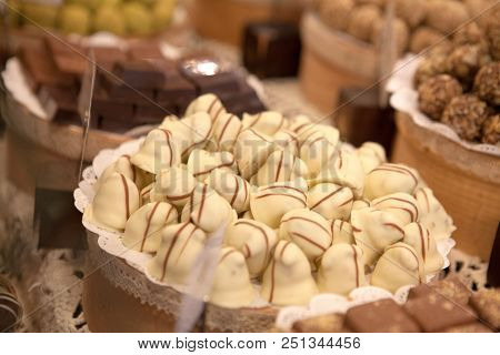 Asorted Chocolate Truffles And Pralines. Chocolate And Coconut Candies On The Counter In The Confect
