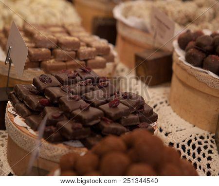 Asorted Chocolate Truffles And Pralines. Chocolate And Coconut Candies On The Counter In The Confect
