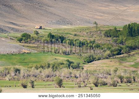 The Frame Of An Unfinished Wooden House On A Mountain Slope, Amidst Wild Vegetation. The Republic Of