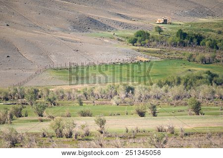 The Frame Of An Unfinished Wooden House On A Mountain Slope, Amidst Wild Vegetation. The Republic Of