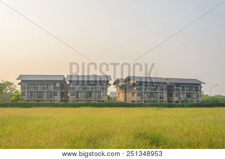 Residence Building Is Located On A Beautiful Yellow Meadow In The Morning.