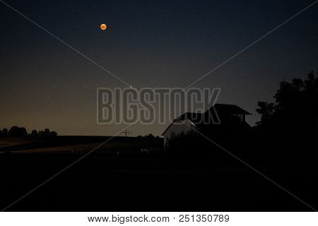 Full Bloodmoon And Mars Over German Landscape
