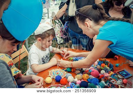 Zaporozhia/ukraine- June 2, 2018: Charity Family Festival-young Woman - Volunteer Explaining To Smal
