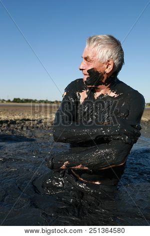 Man Applying Black Healing Clay, Primorsko-akhtarsk, Russia