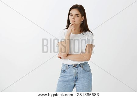 Hmmm, Let Me Think About It. Portrait Of Serious Focused Fashionable European Woman In Jeans And T-s