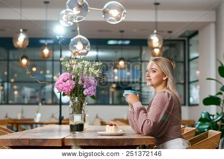 Beatiful Girl Drinking Coffee In Local Cafe With Stylish Interior, Wooden Details. Looking Forward, 