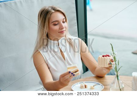 Pretty Blonde Girl Can't Choose Between Two Delicious Cakes.