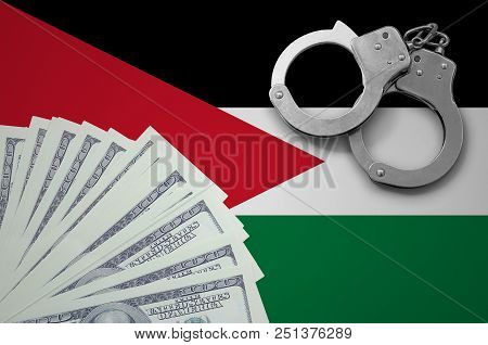 Jordan Flag  With Handcuffs And A Bundle Of Dollars. The Concept Of Illegal Banking Operations In Us