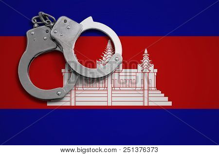 Cambodia Flag  And Police Handcuffs. The Concept Of Crime And Offenses In The Country.